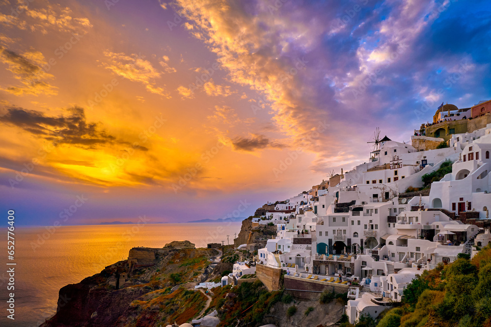 Oia village, windmills, Santorini island, Greece at colorful sunset