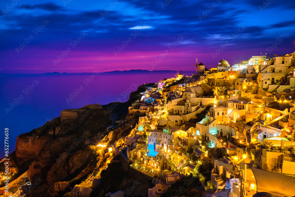 Oia village, windmills, Santorini island, Greece at colorful sunset