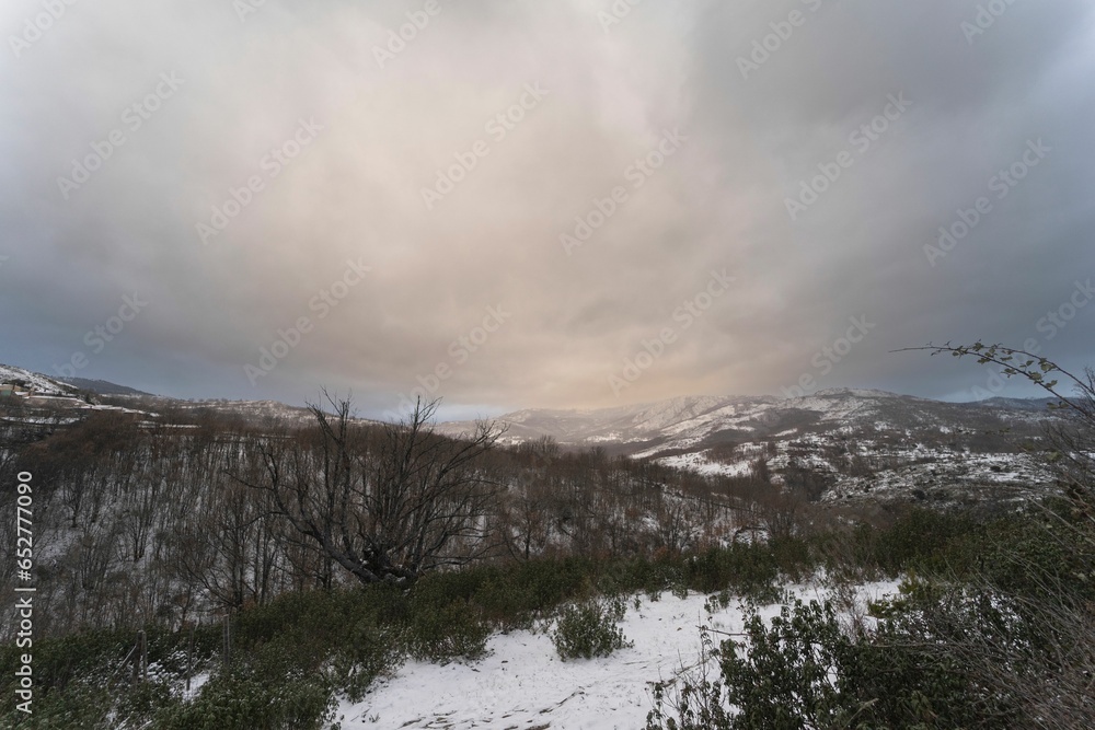 Panoramic view of the snowy mountains in the middle of winter in the town of La Hiruela, Madrid.