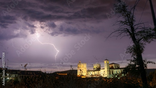 Views of the cathedral of Siguenza illuminated at dusk in the middle of a major thunderstorm.
