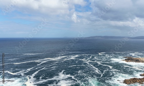 Panoramic view of the Atlantic sea from the city of A Coruna. Blue sky with some clouds and bad sea.