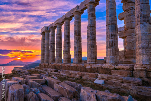 Sunset sky and ancient ruins of temple of Poseidon, Sounion, Greece photo