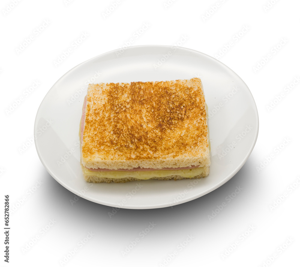 Sandwich de jamon y queso tostado en plato sobre fondo blanco. Toasted ham and cheese sandwich on plate on white background.