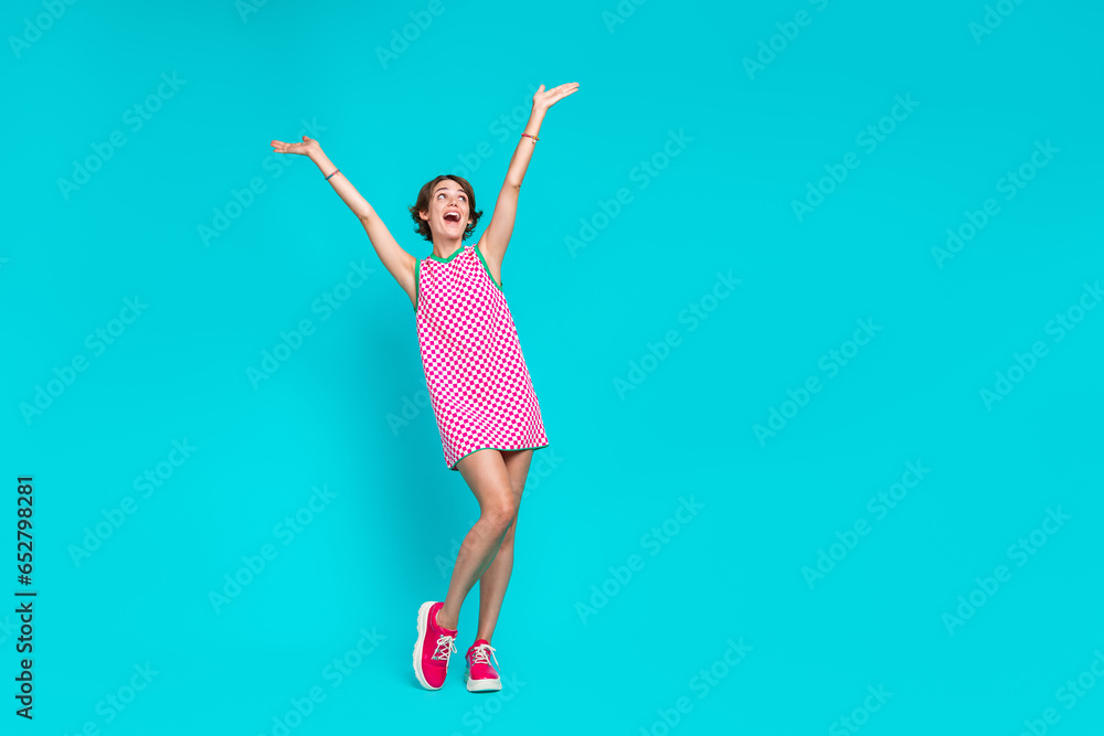 Full length photo of overjoyed lady in trendy sarafan have fun good mood seasonal offer empty space isolated on cyan color background Full length photo of overjoyed lady in trendy sarafan have fun good mood seasonal offer empty space isolated on cyan color background