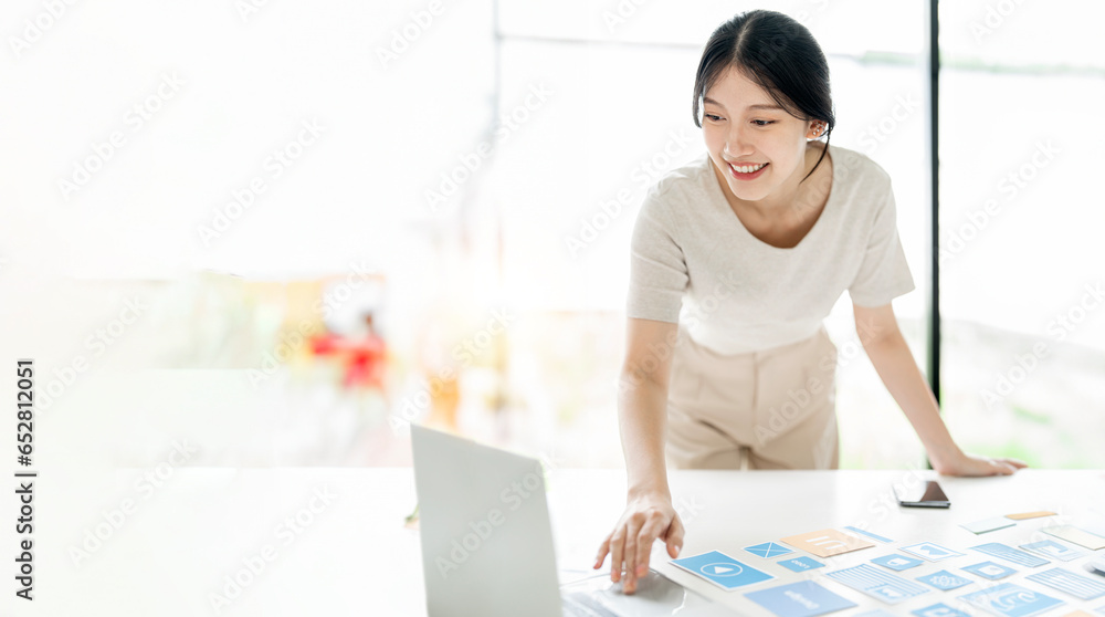 Young happy designer working her new project at office. Young happy designer working her new project at office.
