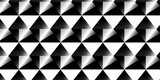 Background consisting of a seamless pattern of painted grungy geometric triangles in black and white. Surface pattern design with a hand-drawn abstract motif in a grungy monochromatic style.