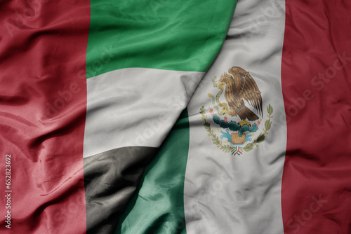 Photography big waving realistic national colorful flag of united arab emirates and national flag of mexico