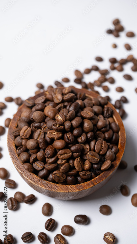 Roasted coffee beans in a wooden cup Roasted coffee beans in a wooden cup