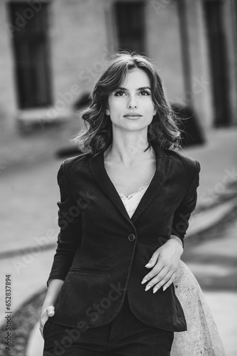 Portrait of a successful business woman in front of modern business building. Young manager poses outside. Woman employee of an office. © romeof