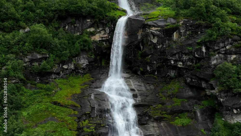 Drone view over cascade Brekkefossen Waterfall on green mountain in Norway Drone view over cascade Brekkefossen Waterfall on green mountain in Norway