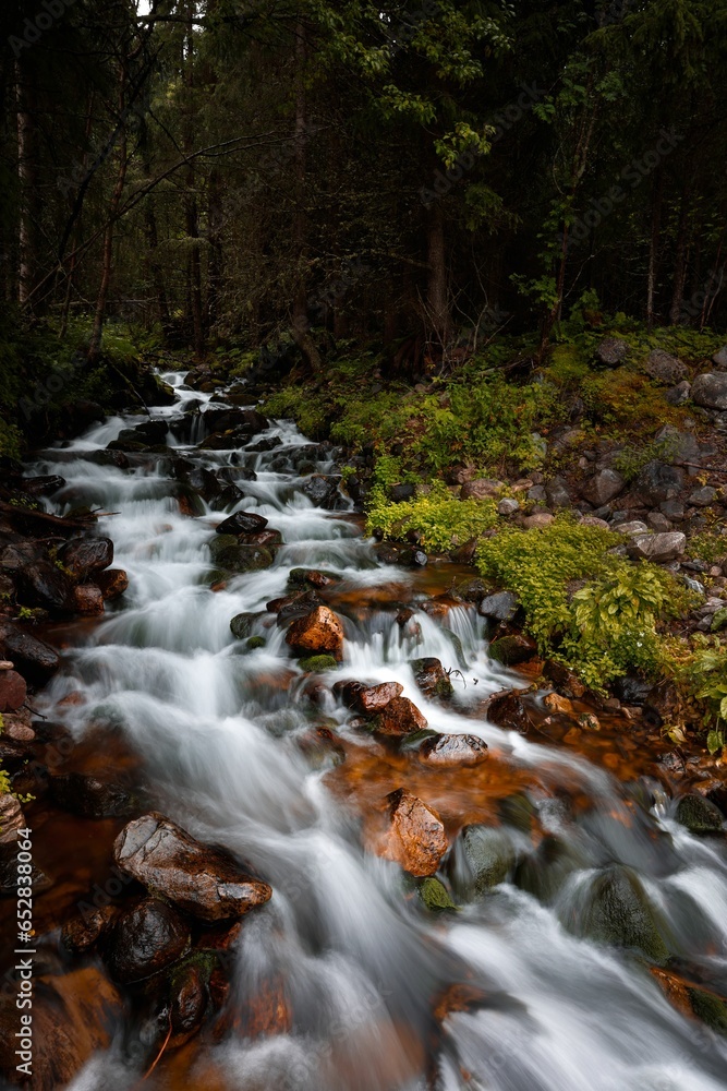 Long exposure of a stream of water winding its way through a rocky landscape