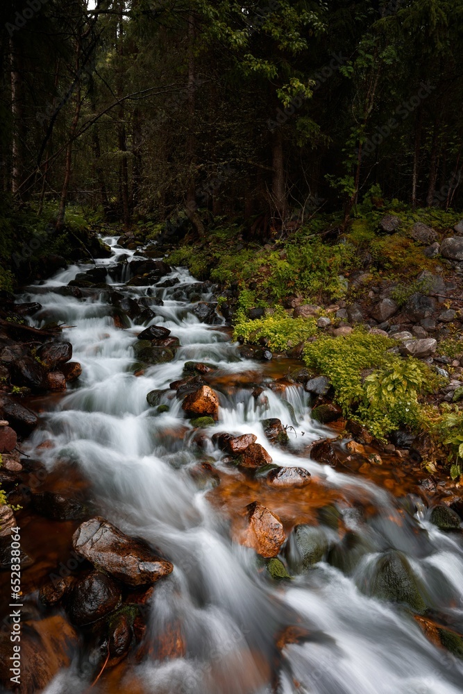 Long exposure of a stream of water winding its way through a rocky landscape Long exposure of a stream of water winding its way through a rocky landscape