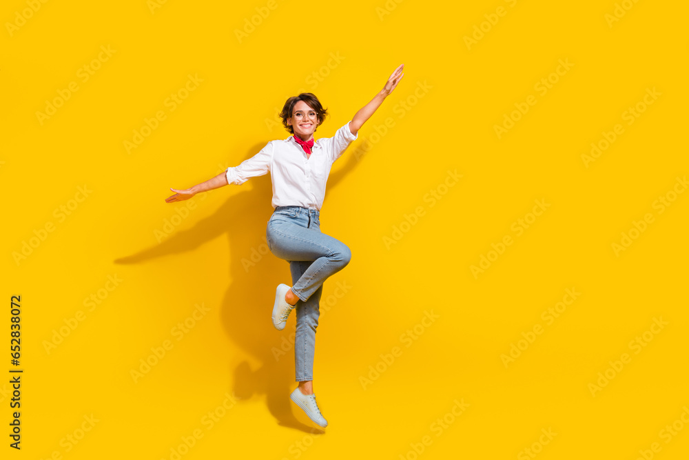 Full length photo of positive charming girl wear stylish outfit celebrate seasonal sale offer isolated on yellow color background