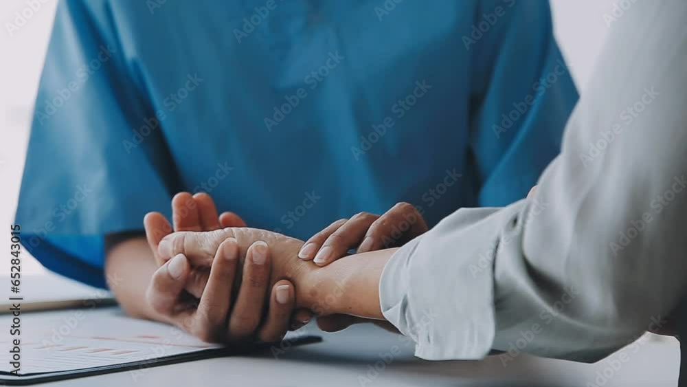 Doctor and patient sitting and talking at medical examination at hospital office, close-up. Therapist filling up medication history records. Medicine and healthcare concept... Doctor and patient sitting and talking at medical examination at hospital office, close-up. Therapist filling up medication history records. Medicine and healthcare concept...