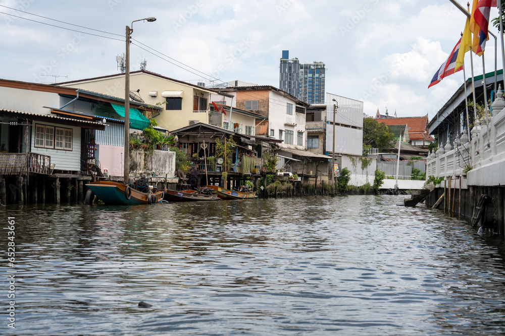 A klong or river channel of Chao Phraya river with residential buildings in Bangkok Thailand Asia