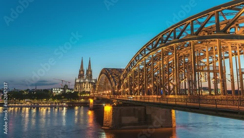Cologne (Köln) Germany time lapse 4K, city skyline day to night timelapse at Cologne Cathedral (Cologne Dom) with Rhine River and Hohenzollern Bridge photo