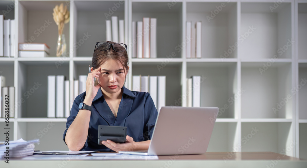 Fototapeta premium The accountant is stressed while calculating the mismatched taxes and finances.