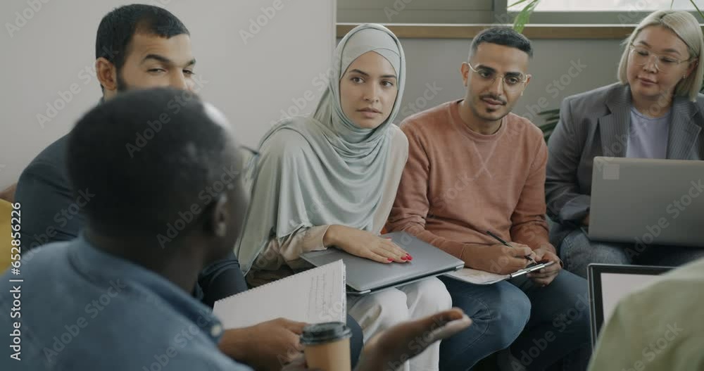 Ambitious men and women diverse team talking sharing business ideas in coworking office. Businesspeople and communication concept. Ambitious men and women diverse team talking sharing business ideas in coworking office. Businesspeople and communication concept.