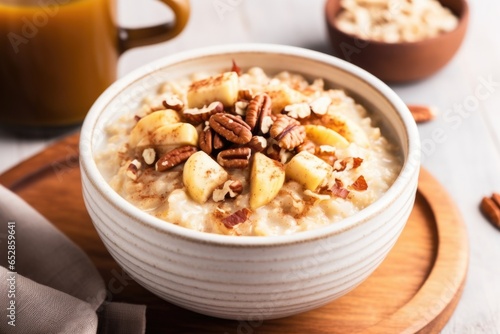 cooked oatmeal topped with bananas and walnuts