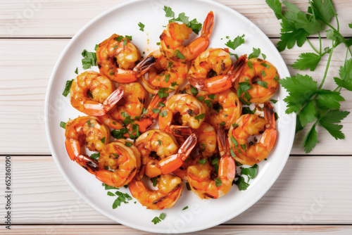 grilled shrimp with chopped parsley on white plate and white surface