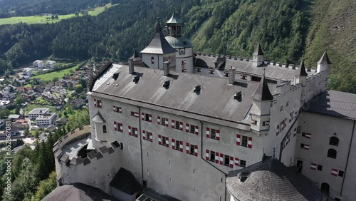 Hohenwerfen Fortress in the Pongau region of Salzburg. On the steep peak, high above the Salzach valley Austrian Alps, Austria, Europe. Medieval rock fortress. Aerial. Summer.