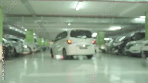 Modern underground parking with blurred unrecognizable moving cars 4K photo