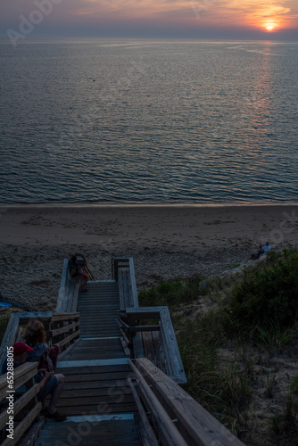 stairway people watching the sun set over the Cape cod bay