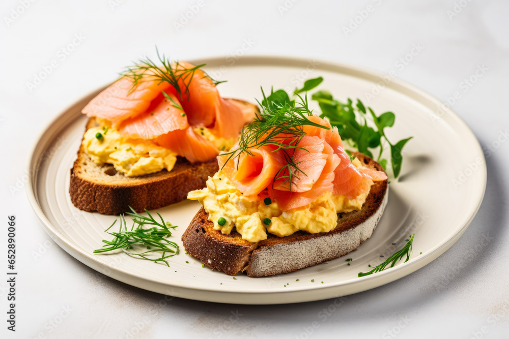 Scrambled eggs with salmon on sourdough served on a minimalist white table 