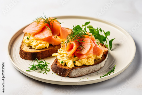 Scrambled eggs with salmon on sourdough served on a minimalist white table 