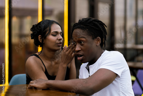 love romantic date of two black persons, telling a secret in the ear
