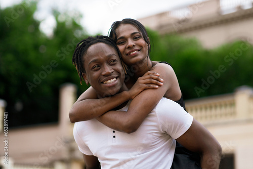 happy black male and female in love, cheerful couple outdoors