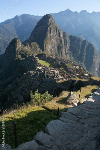 Panorama of Machupicchu with view of the mountains and archeological site, along with a stone staircase to the ruins, in Peru, Sacred Valley. 