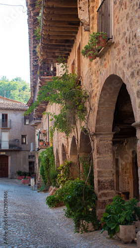Stone arches of an old manor house in a rural village in Catalonia.