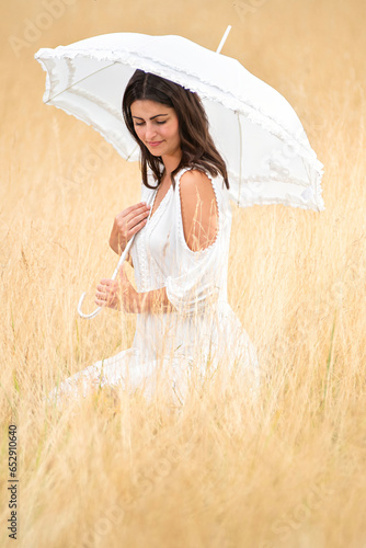 pensive woman with umbrella and dress photo