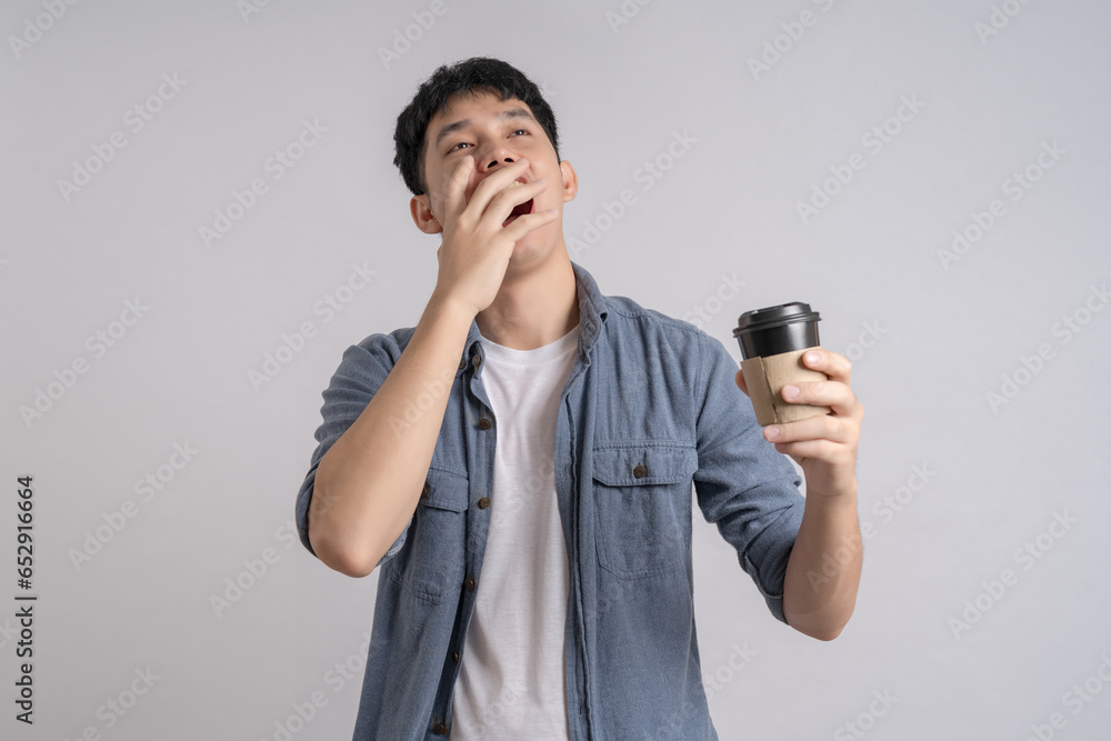 Man holding paper cup with hot coffee and smiling happily. Man holding paper cup with hot coffee and smiling happily.