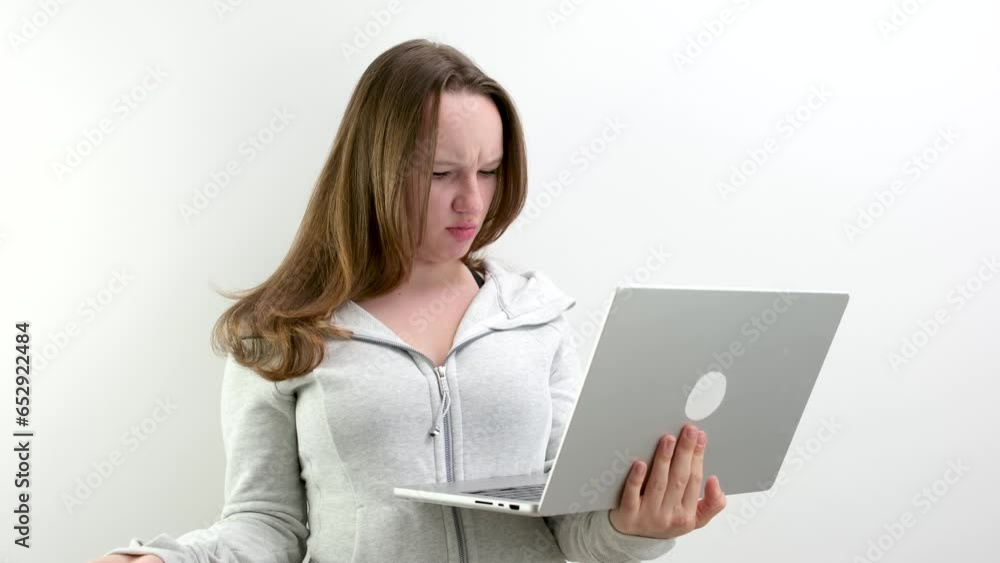 dissatisfied with working on the computer pressing buttons speaking evil young teenage girl opening her mouth waving her hand indignant bad task communication online. negative emotions indignation dissatisfied with working on the computer pressing buttons speaking evil young teenage girl opening her mouth waving her hand indignant bad task communication online. negative emotions indignation