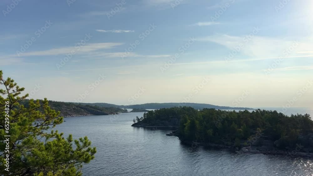 Russia, Karelia, Lake Ladoga, Koyonsaari. View of the coast of the island in a cold lake. Beautiful nature of the Republic of Karelia. Stunning panoramic view of the Ladoga Skerry Islands. 4K Russia, Karelia, Lake Ladoga, Koyonsaari. View of the coast of the island in a cold lake. Beautiful nature of the Republic of Karelia. Stunning panoramic view of the Ladoga Skerry Islands. 4K