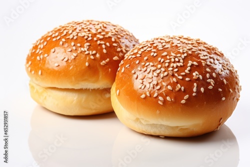 Two buns with sesame seeds isolated on white background