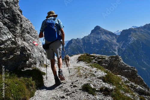 Mann und sein Lagotto Romagnolo Hund wandern im Stubaital in Tirol  photo
