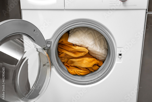 Washing large blankets and pillows in the washing machine.