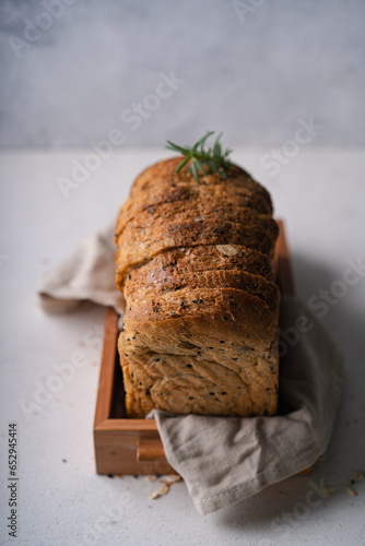 Fresh Sliced Homemade Wholegrain Wheat Bread on white rustic background. Artisan Sourdough