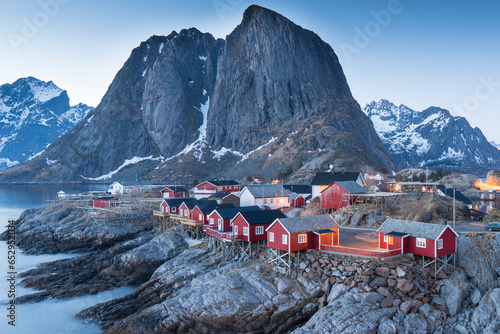 Traditional Norwegian fisherman s cabins, rorbuer, on the island of Hamnøy, Reine on the Lofoten in northern Norway. Photographed at dawn in winter. photo