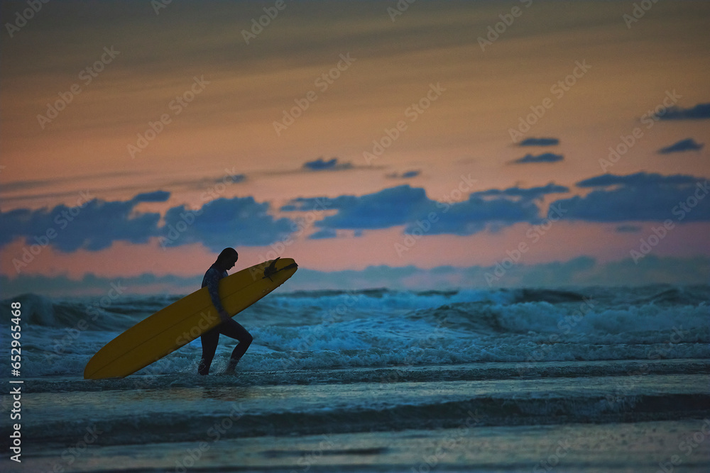 Surfer in the North Sea in the Netherlands at night