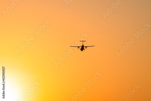Silhouette of an ATR 72-500 Turboprop Aircraft against sunset