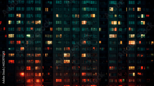 Night view of apartment building windows, an indicator of neighborhood and social life. Generative AI