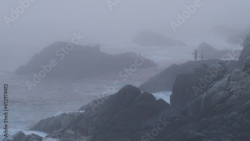 Silhouette of Man Fishing on Misty Coastline of Carmel By The Sea and Big Sur - a Rugged Stretch of California Central Coast known for Winding Roads and Seaside Cliffs