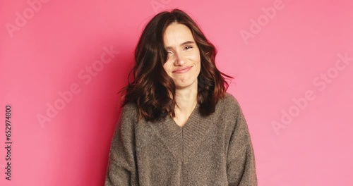 Brunette woman looking camera pointing fingers herself ask me no i do not need it. Girl waving her hands and say no isolated on pink background. Woman wear warm sweater