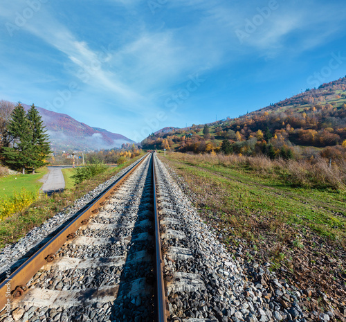 Autumn Carpathian Mountains misty landscape with  railroad bridge and village outskirts (Rakhiv district, Transcarpathia, Ukraine). photo