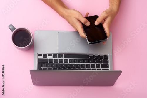 Typing text. Hand using gadgets, device on top view, blank screen with copyspace, minimalistic style. Technologies, modern, marketing. Negative space for ad. Coral color on background. Stylish, trendy