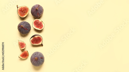 Fresh ripe figs on yellow background with space for text, top view